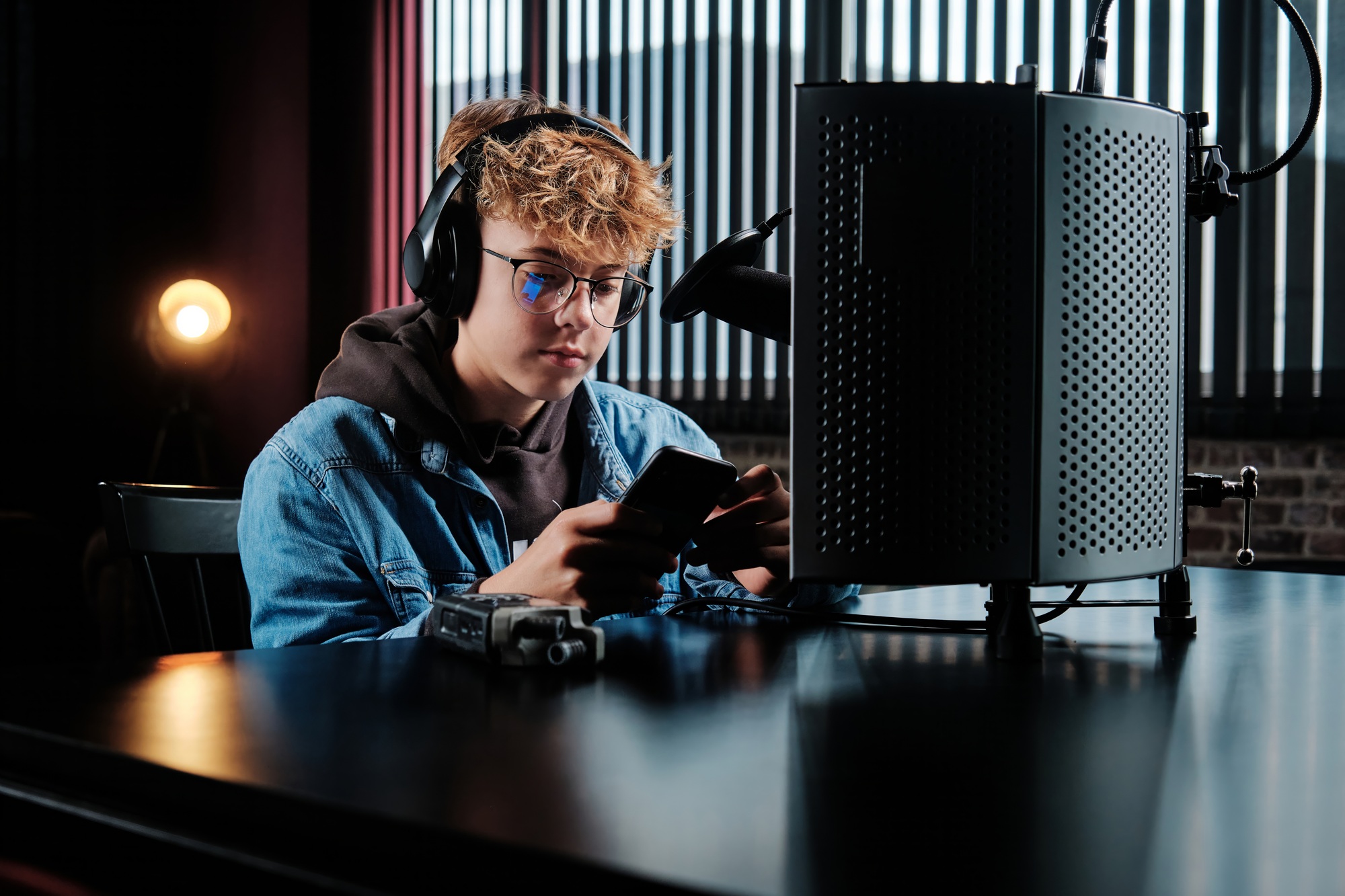 Young Podcaster in Studio Setting with Recording Equipment